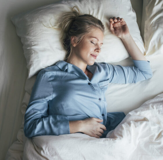 Sound Asleep: Overhead Waist Up Shot of a Pretty Blonde Woman in Blue Pyjamas Sleeping on a King Size Bed